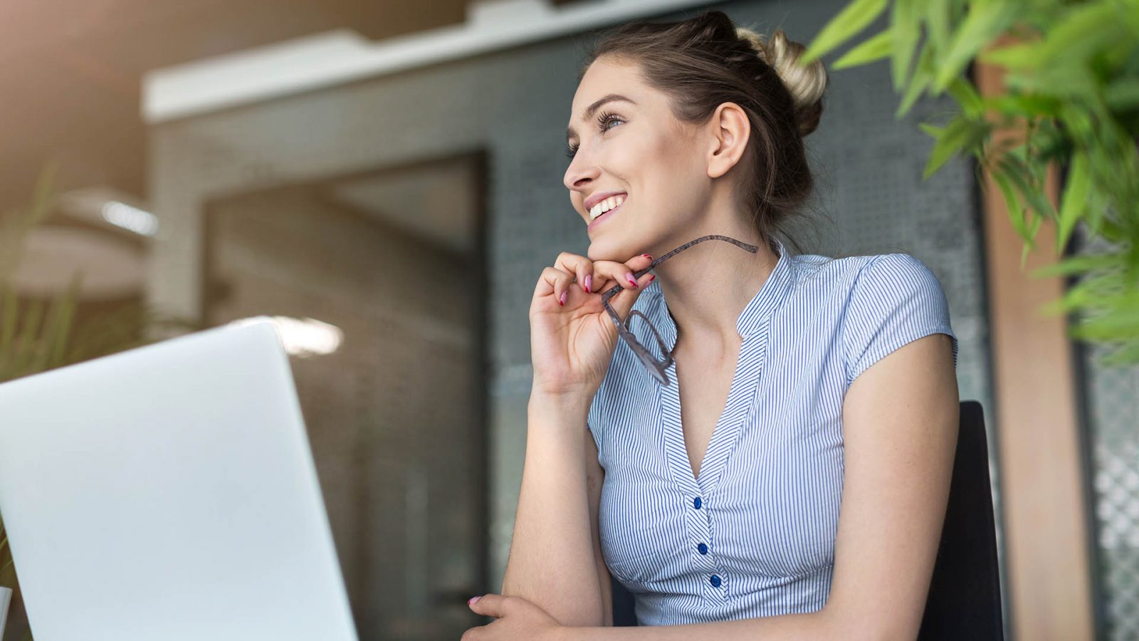 Young business woman working on laptop in office